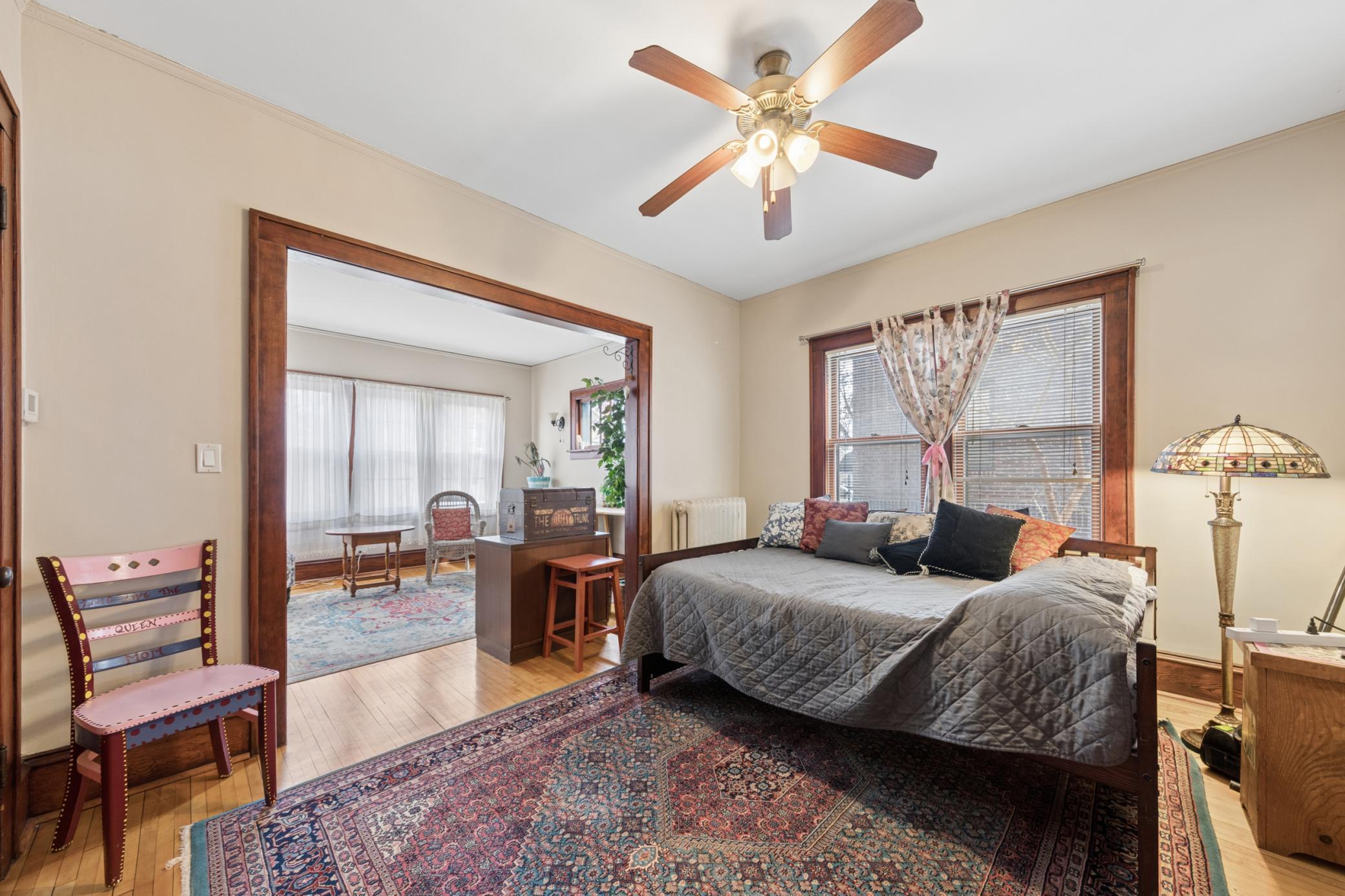 Inviting formal dining area with rich wood floors, abundant natural light, and a seamless connection to the adjacent living space