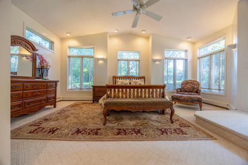 Spacious primary retreat with abundant natural light and views of the lush perennial garden.