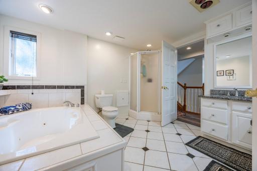 Durable, high quality tile paired with a generously sized bathroom tub.