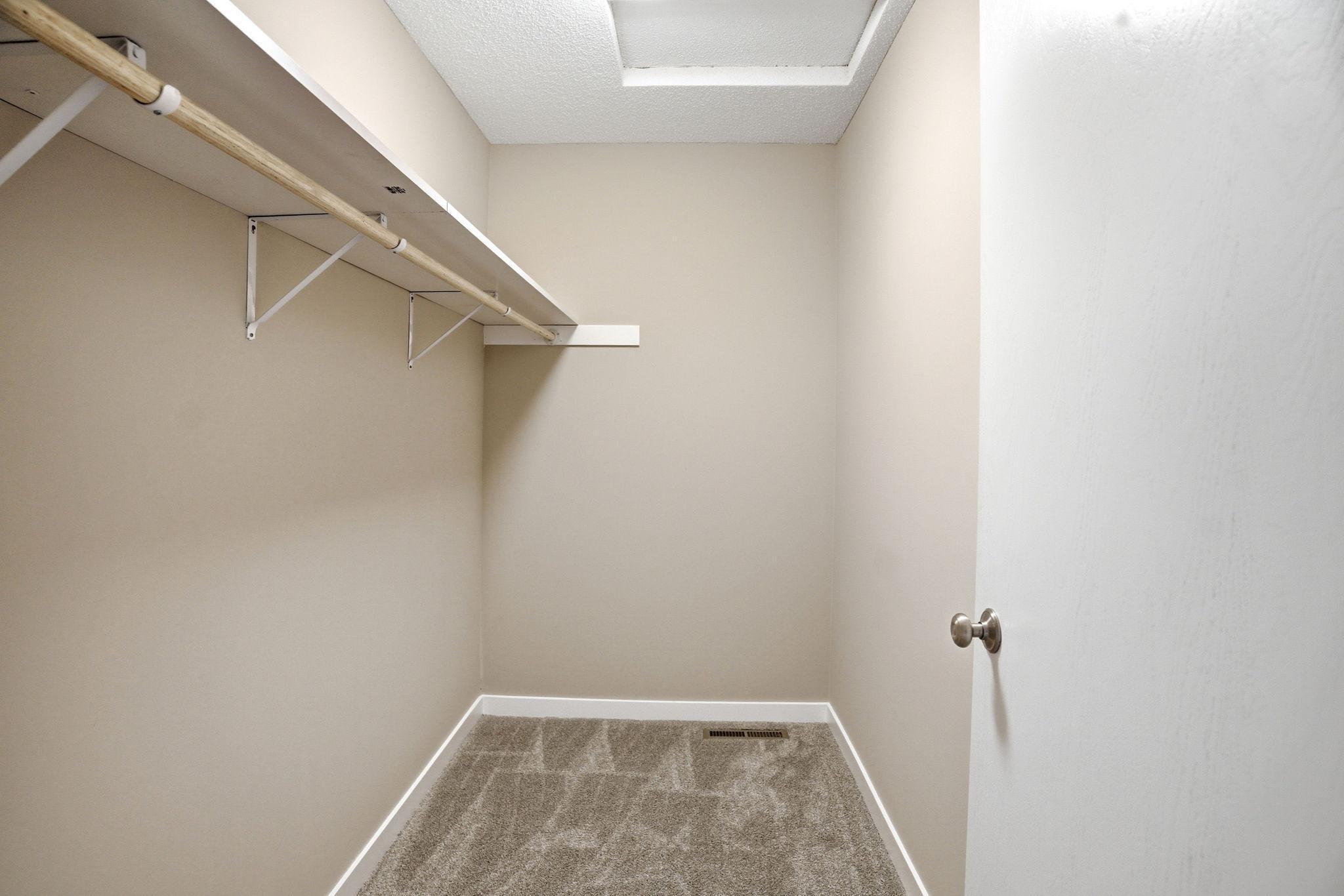 Primary bedroom walk-in closet