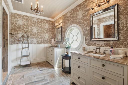 The attached private bathroom is elegantly appointed. It includes a spacious walk-in shower and luxurious finishes, ensuring a spa-like experience.