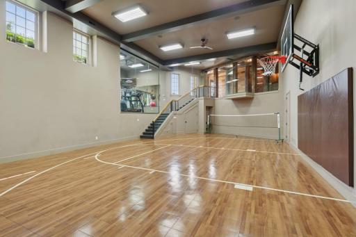 The full sport court is a stunning feature, enclosed by glass walls.