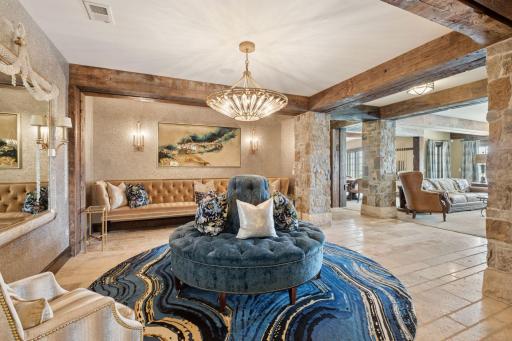 Heading downstairs, you enter a full entertainer's dream that exudes luxury and style. The expansive open layout is perfect for hosting gatherings, featuring a spacious lounge area adorned with plush seating and elegant decor.