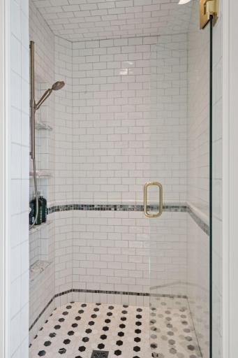 Stunning tile walk-in shower in upper level bedroom 1.