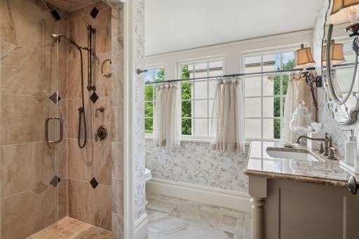 Connected to the sitting room is a private bathroom, complete with luxurious finishes. A spacious shower, elegant fixtures, and tasteful decor.
