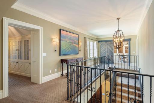 Enter the hallway which lead to the upper level office, bedrooms, and laundry room.