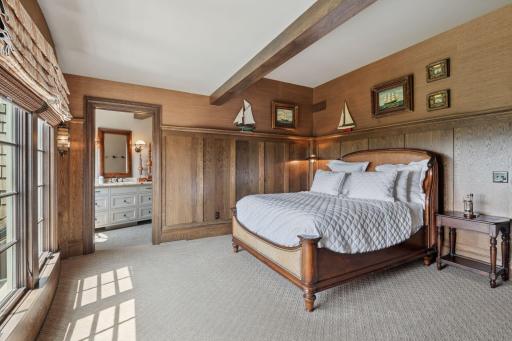 The 3nd upper level bedroom is a warm and inviting space, characterized by rich wood tones that create a cozy, rustic atmosphere.