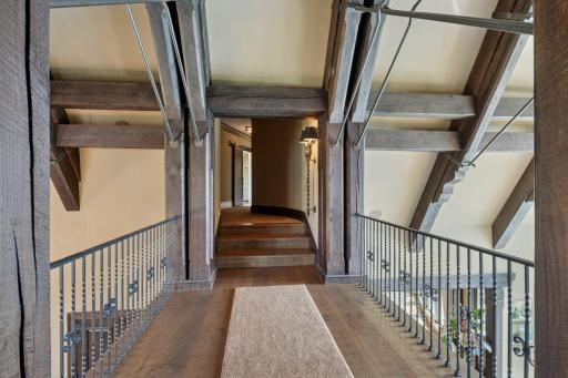 The catwalk serves as a stylish transition, connecting the upper level to the main living areas while maintaining an open, flowing layout. This unique feature not only adds architectural interest but also allows for a seamless journey back downstairs