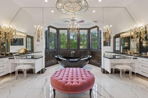 As you move into the bathroom, you're greeted by opulent finishes—a spacious soaking tub, a walk-in steam shower, and dual vanities.