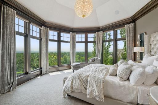 The main floor primary suite is a true sanctuary, offering stunning panoramic views from every angle.