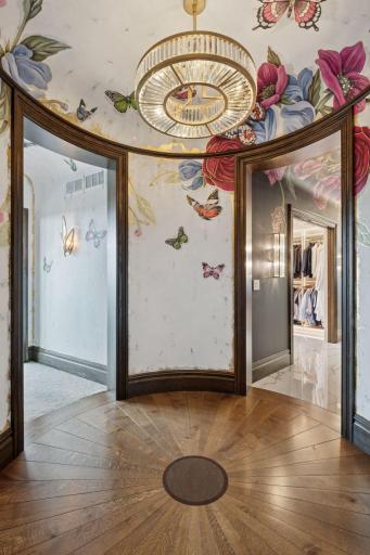 As you enter the rotunda, you're immediately captivated by the stunning custom hand-painted walls. This beautiful space serves as a grand transition to the owner's primary retreat.