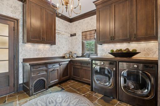 The main floor mudroom is designed for convenience and organization. Featuring ample storage. A well-equipped laundry area is integrated seamlessly. Adding to the functionality, a charming doggie door leads out to the garage.