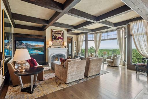 Off the dining room, a cozy sitting room beckons, featuring a charming wood fireplace that adds warmth and a touch of elegance.