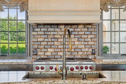 The kitchen is equipped with top-of-the-line appliances, including a gas Wolf stove.