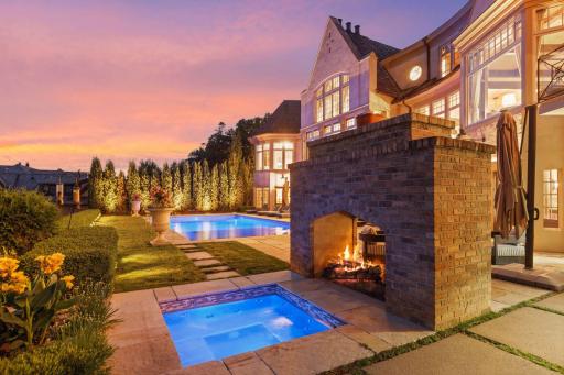 Adjacent to the pool, is a luxurious hot tub. Surround by the 2 sided gas fireplace.