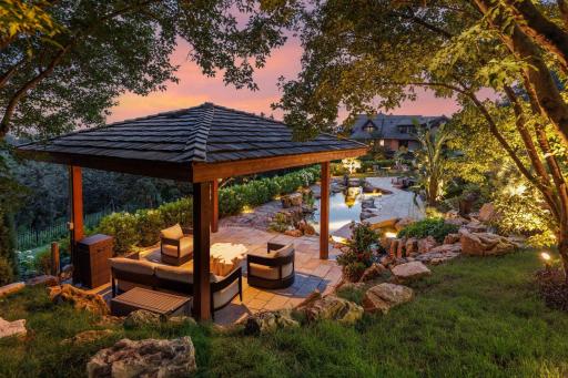 Outside landscaping architect TOPO, LLC. created serene privacy with apple trees, koi pond, and waterfalls.