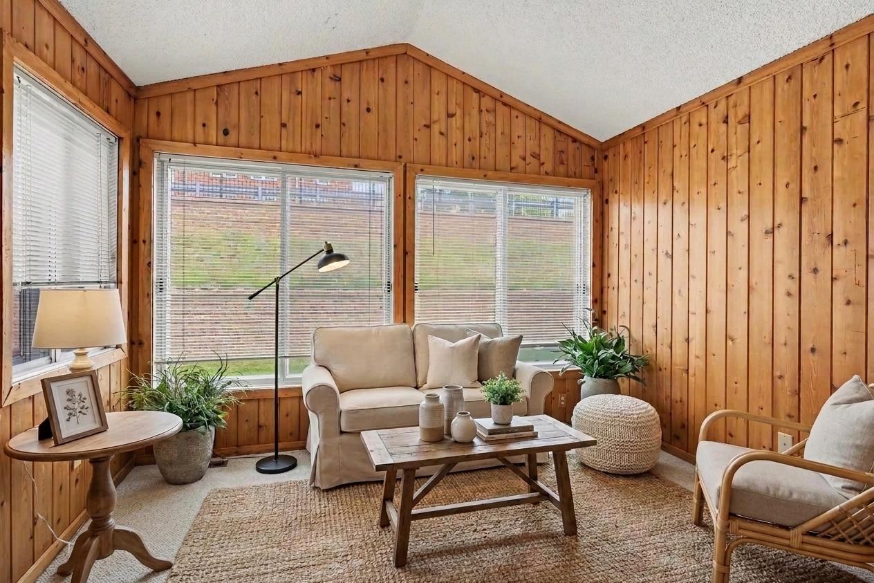 Knotty pine sunroom with vaulted ceiling, virtually staged, the standout room in this Apple Valley MN townhome