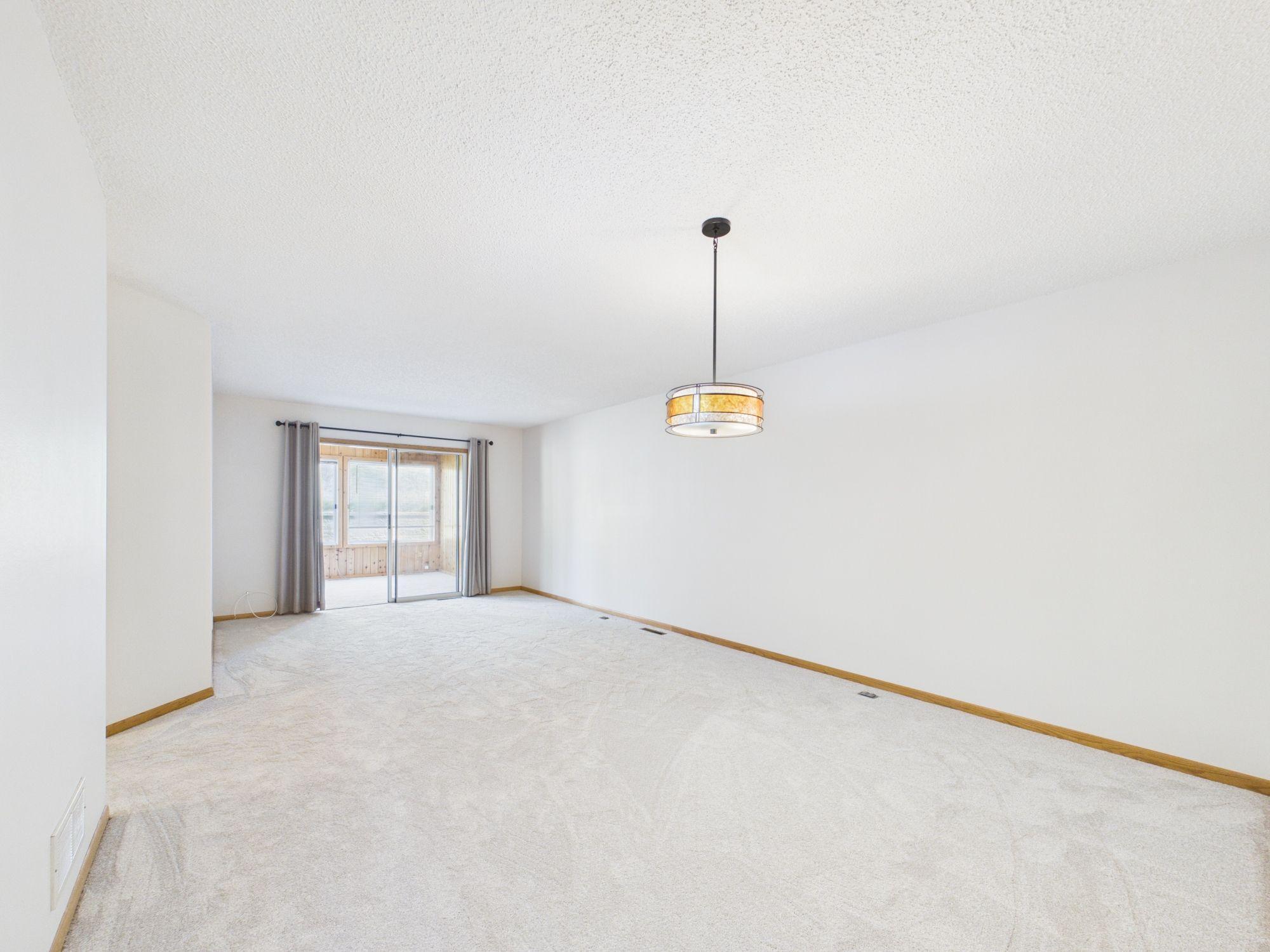 Living room shown unfurnished, true scale of this Apple Valley one-level townhome layout. All freshly painted with new carpet.