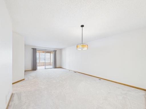 Living room shown unfurnished, true scale of this Apple Valley one-level townhome layout. All freshly painted with new carpet.