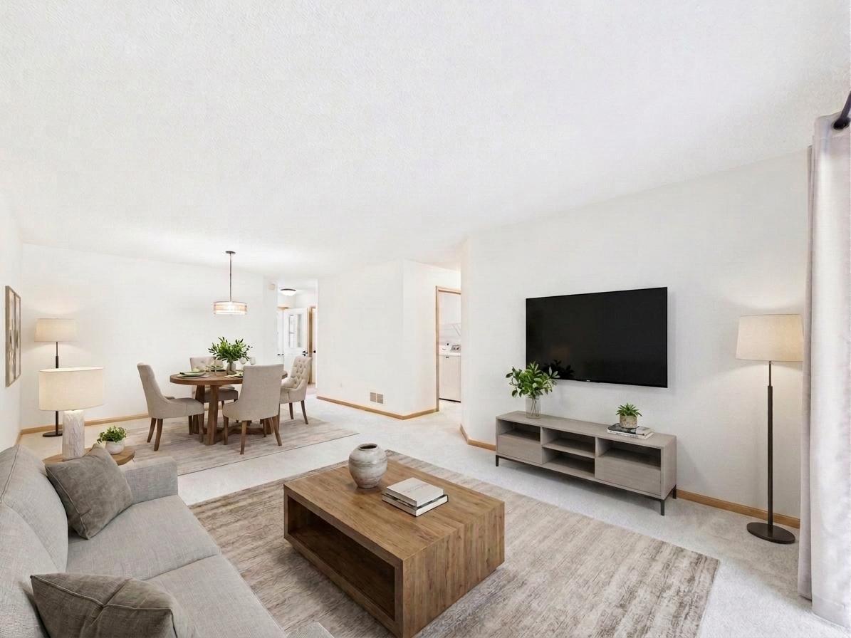 Living room in this 2 bedroom Apple Valley MN townhome, virtually staged to show furniture layout and flow into the dining area