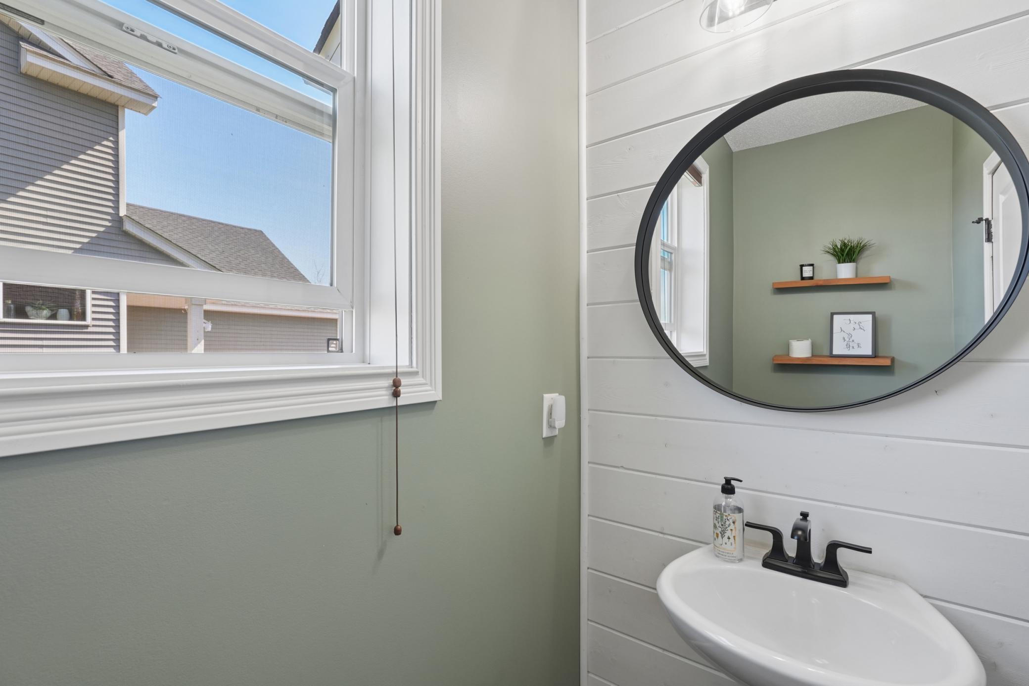 Main level 1/2 bath with ship lap and modern decor