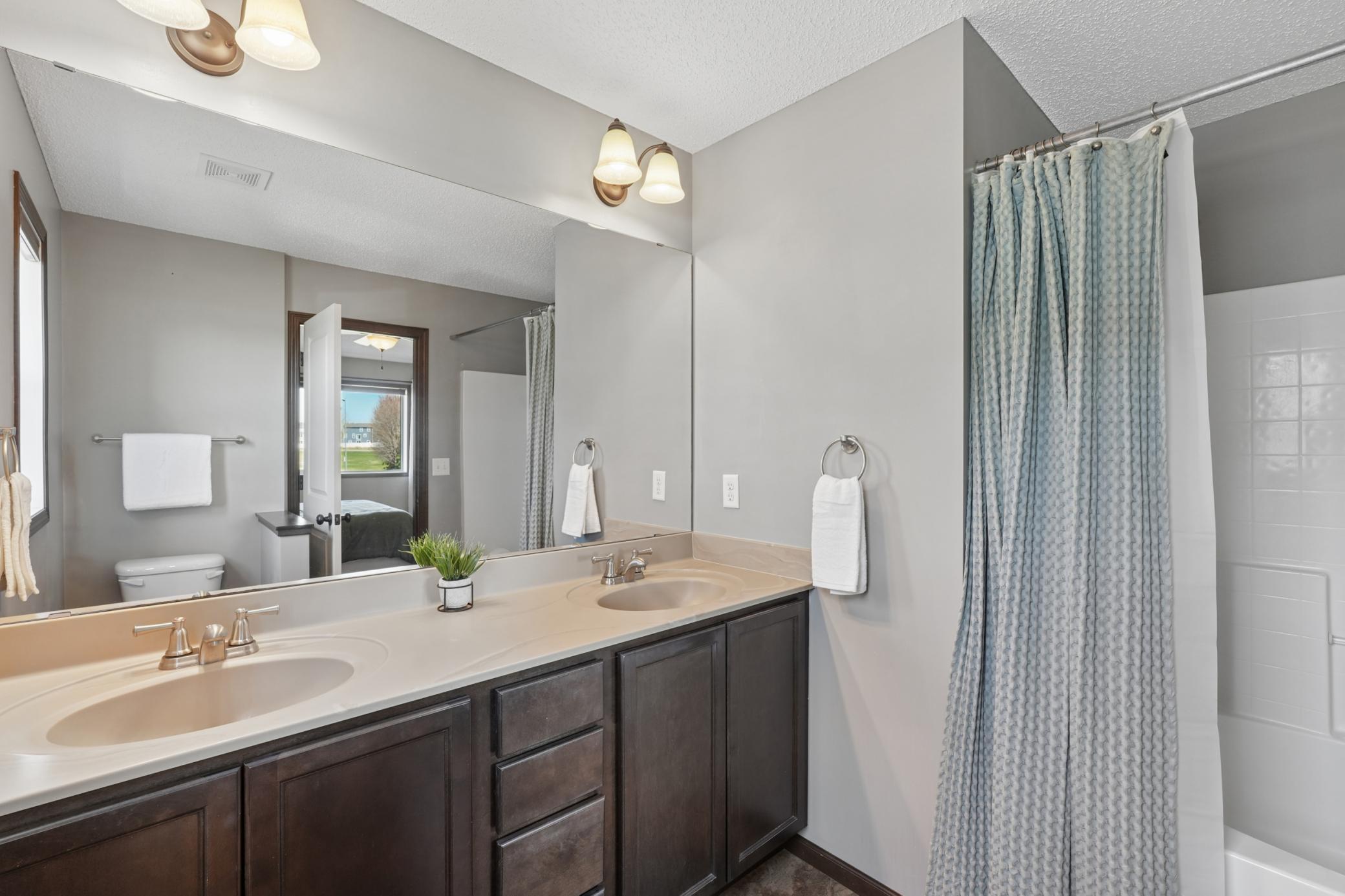 The private full bath in the primary bedroom includes a large bathtub and shower.