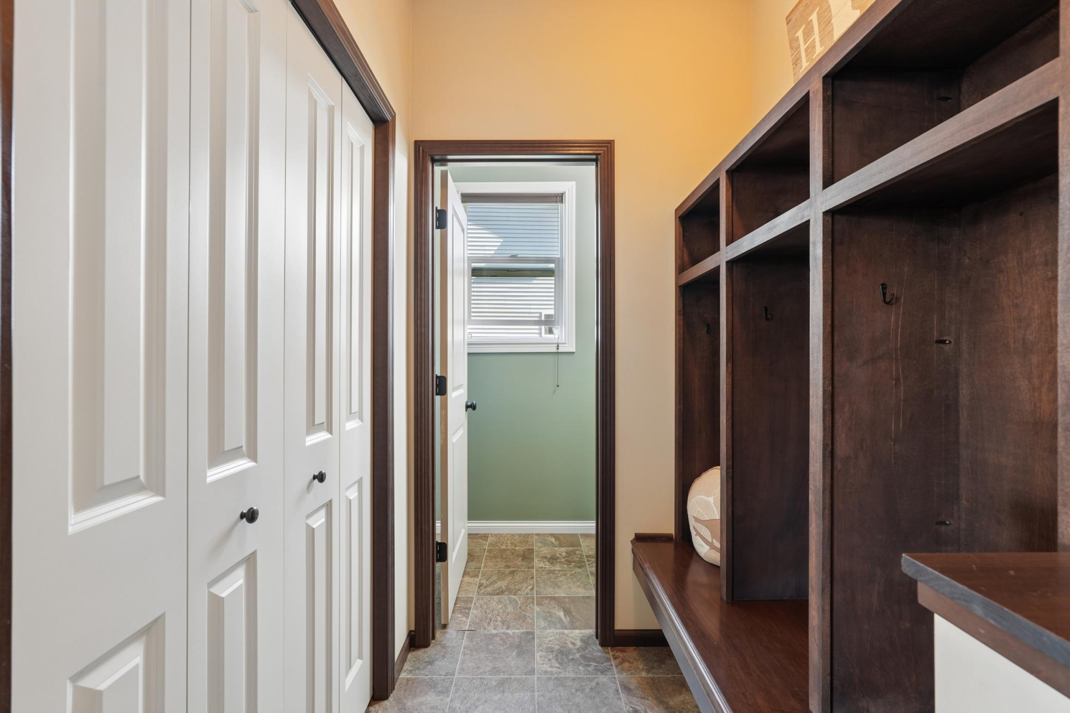 Mudroom with storage cubbies and storage closet