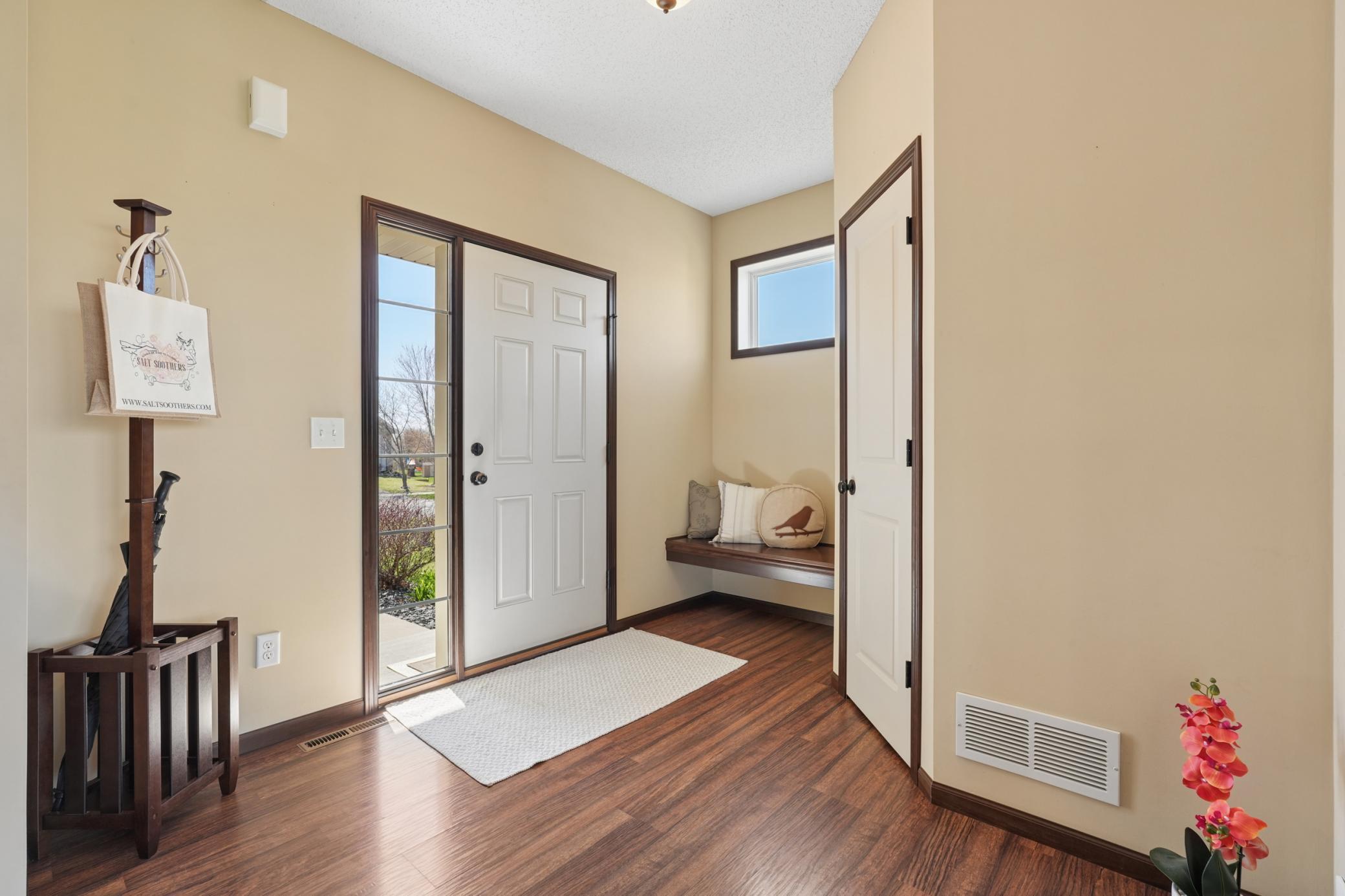 Spacious entry way with bench seating and large walk-in coat closet
