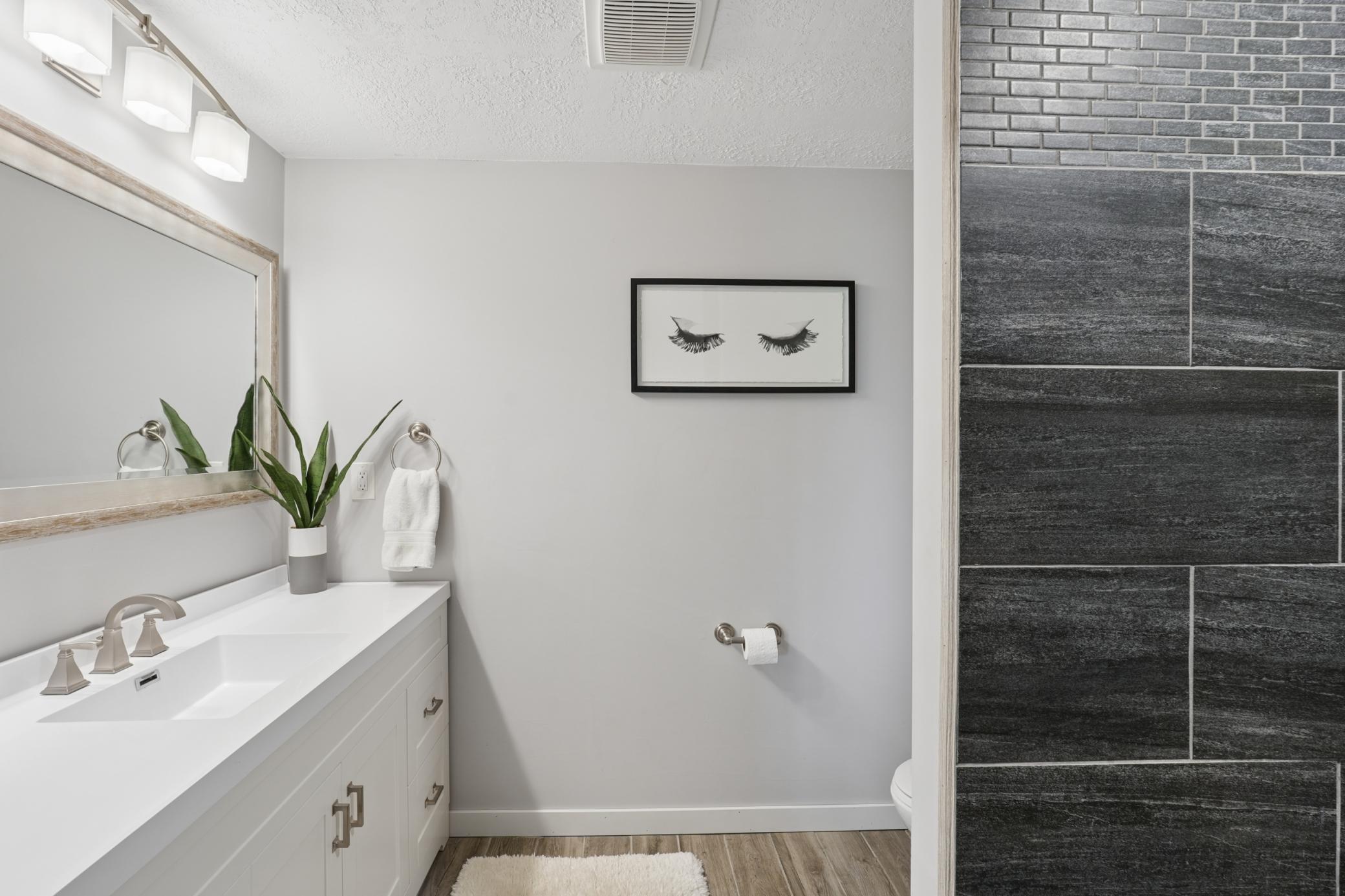 lower-level 3/4 bathroom with walk-in tiled shower