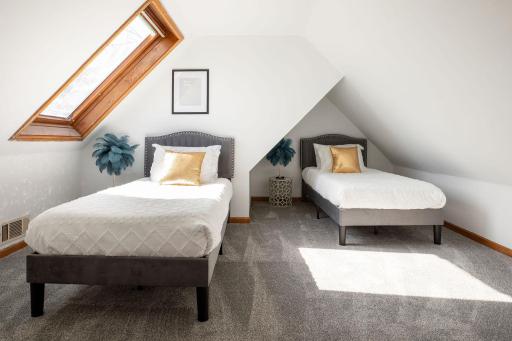 Upper level bedroom with skylight and closet