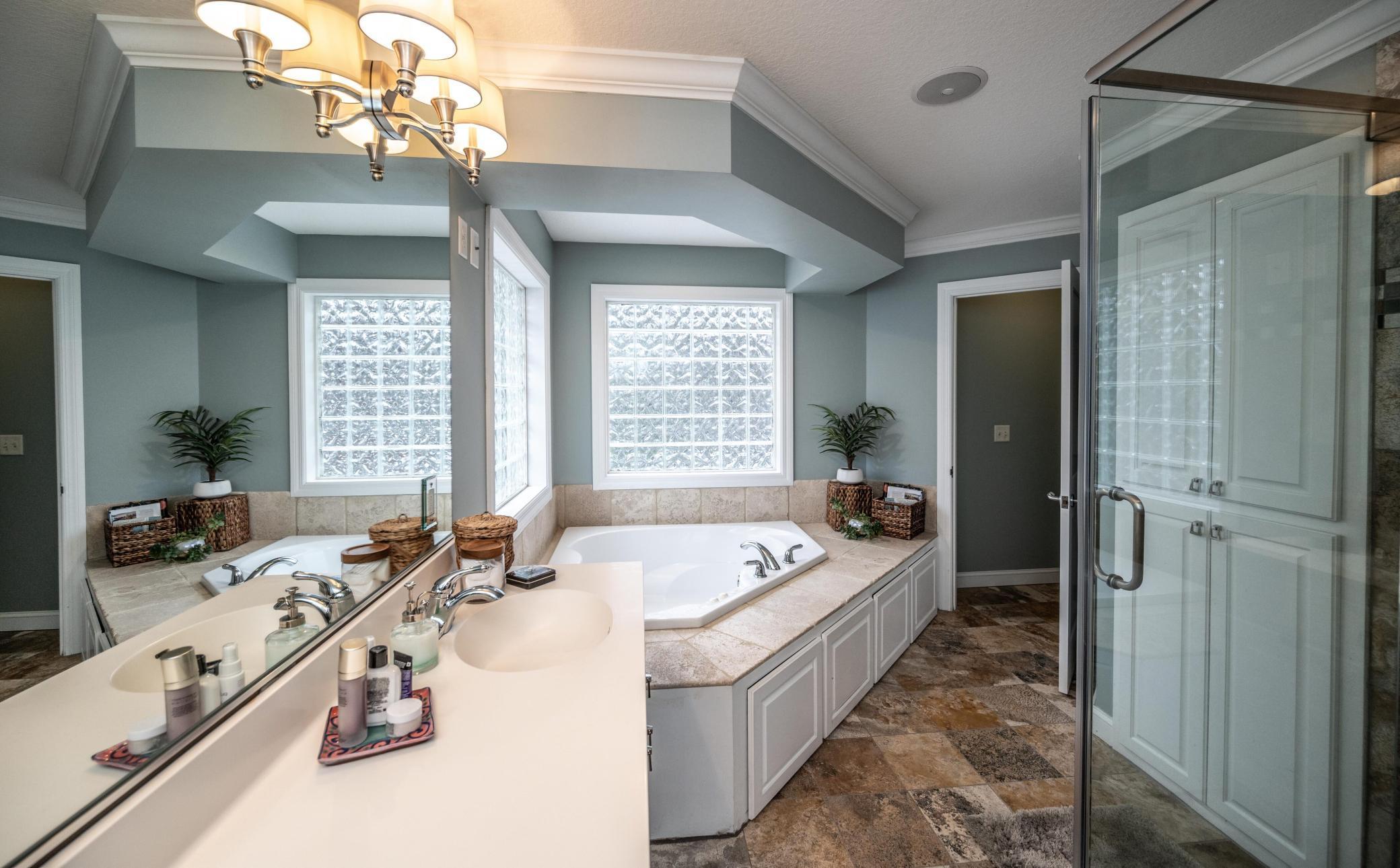 Alternate view of the primary bath - note the large linen closet and separate water closet.