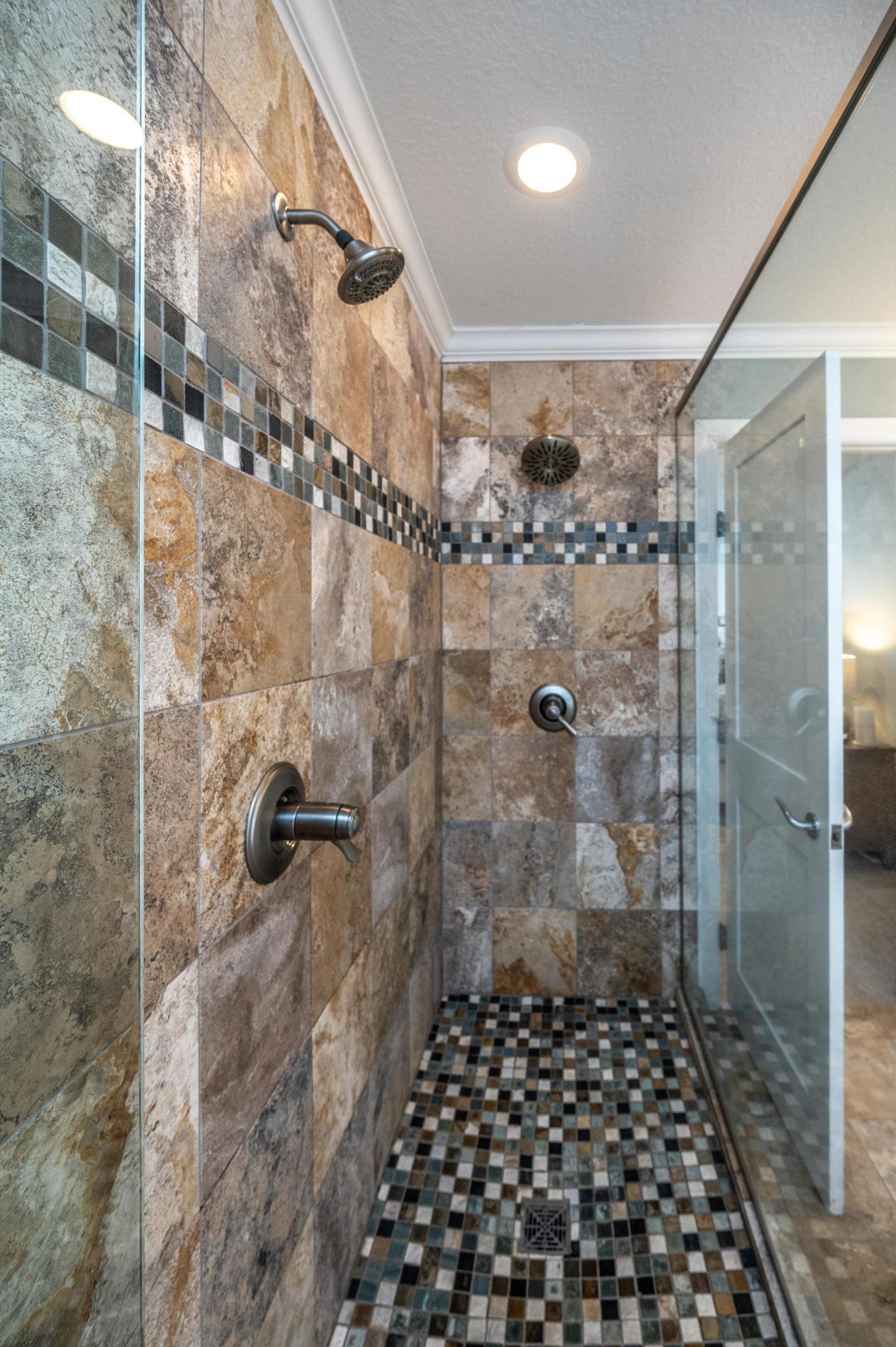 Gorgeous walk-in shower with dual shower heads.