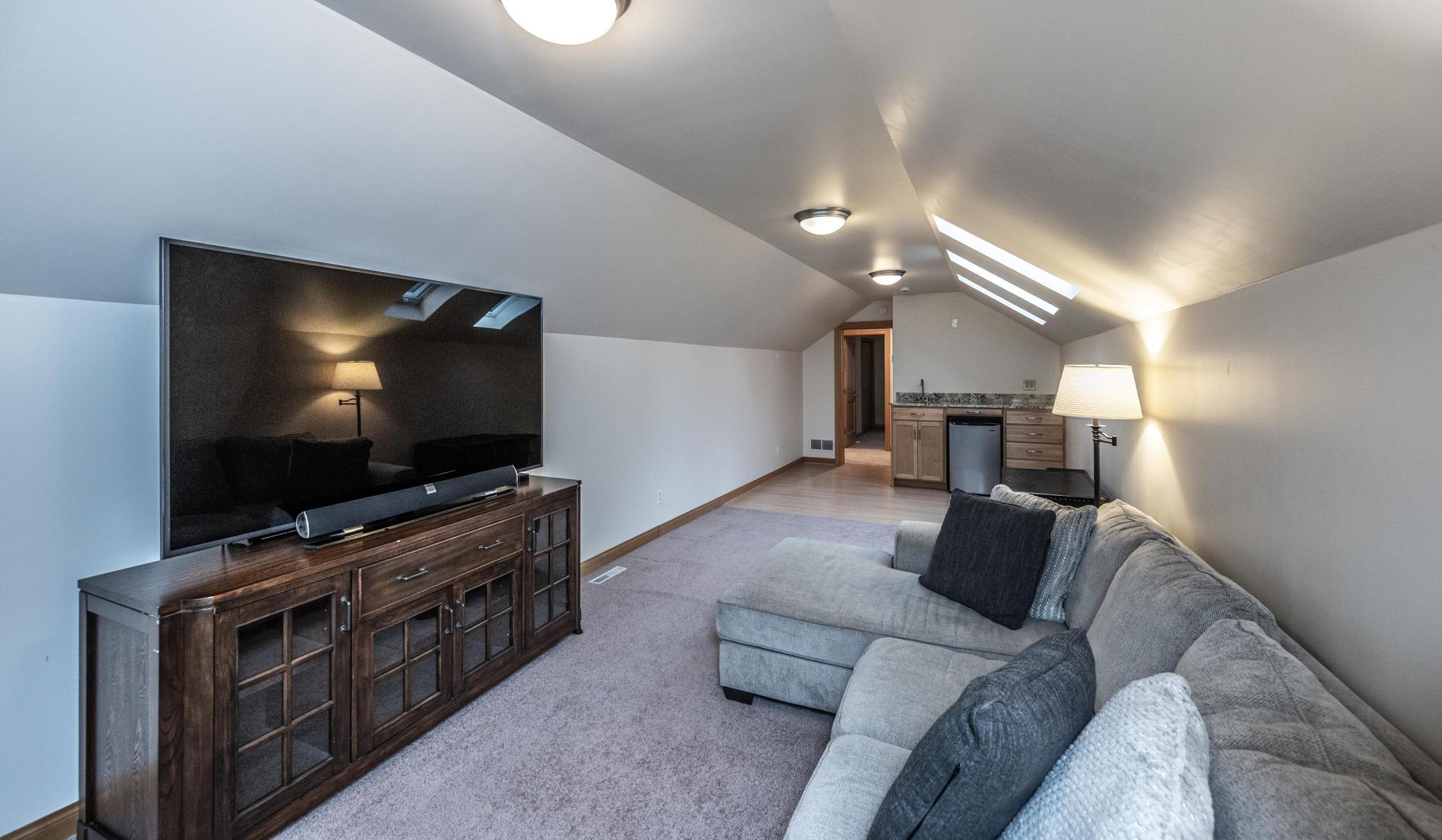 What a bonus room this is! Skylights and vaulted ceilings, this is a perfect hang out area complete with a wet bar. This could also be an additional computer or office area.