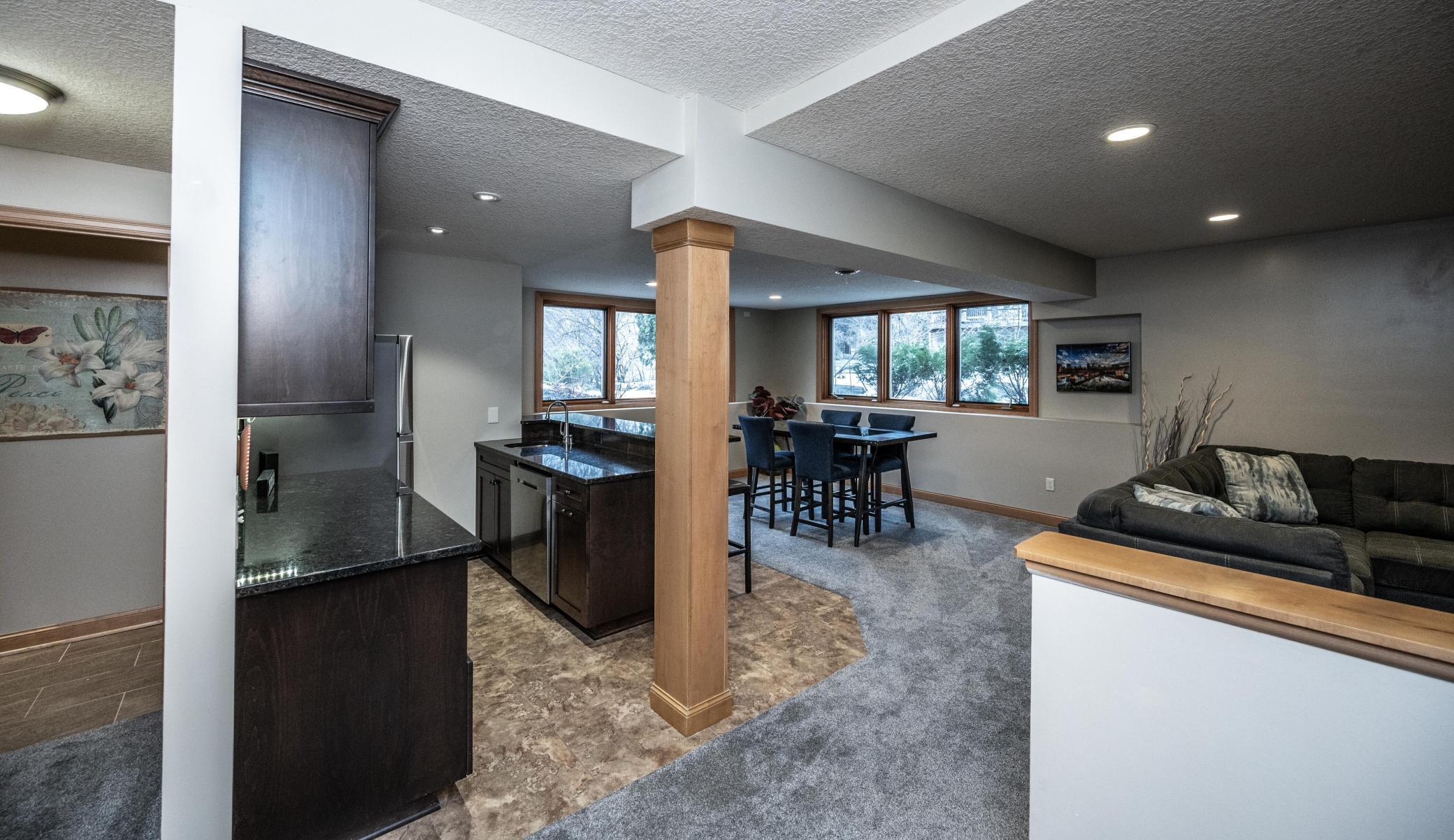 Open and flowing lower level is perfect for entertaining or just hanging out together. Daylight windows bring in much light to the bar and game area.