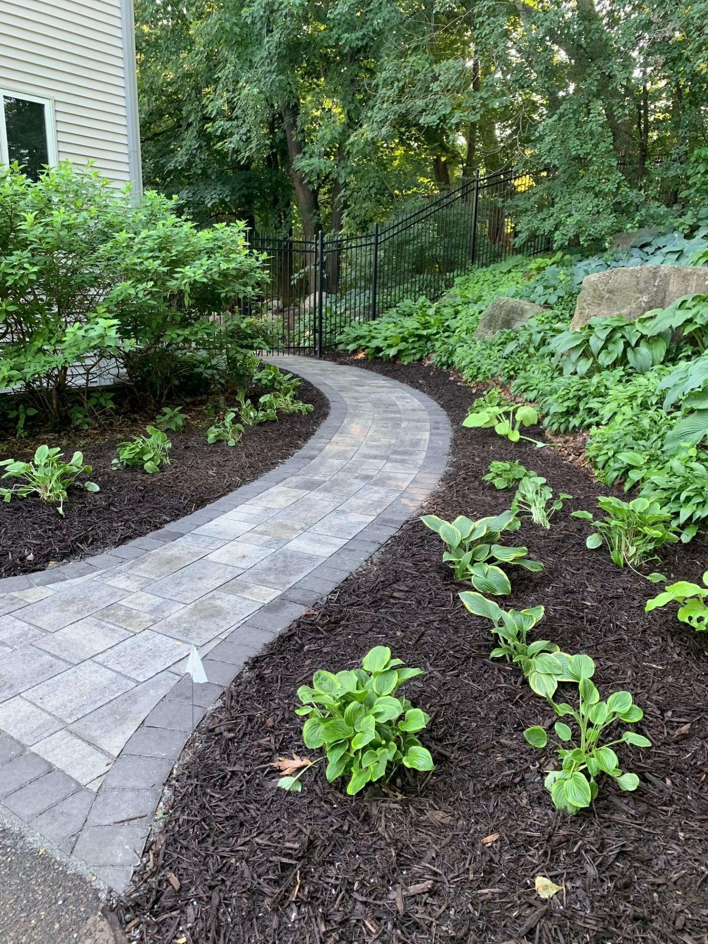 Welcoming paver path recently added. Gorgeous gardens!