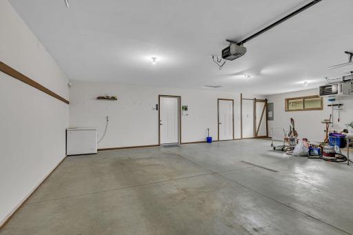 3 car insulated and heated garage with cold water faucet, floor drain, and workshop area