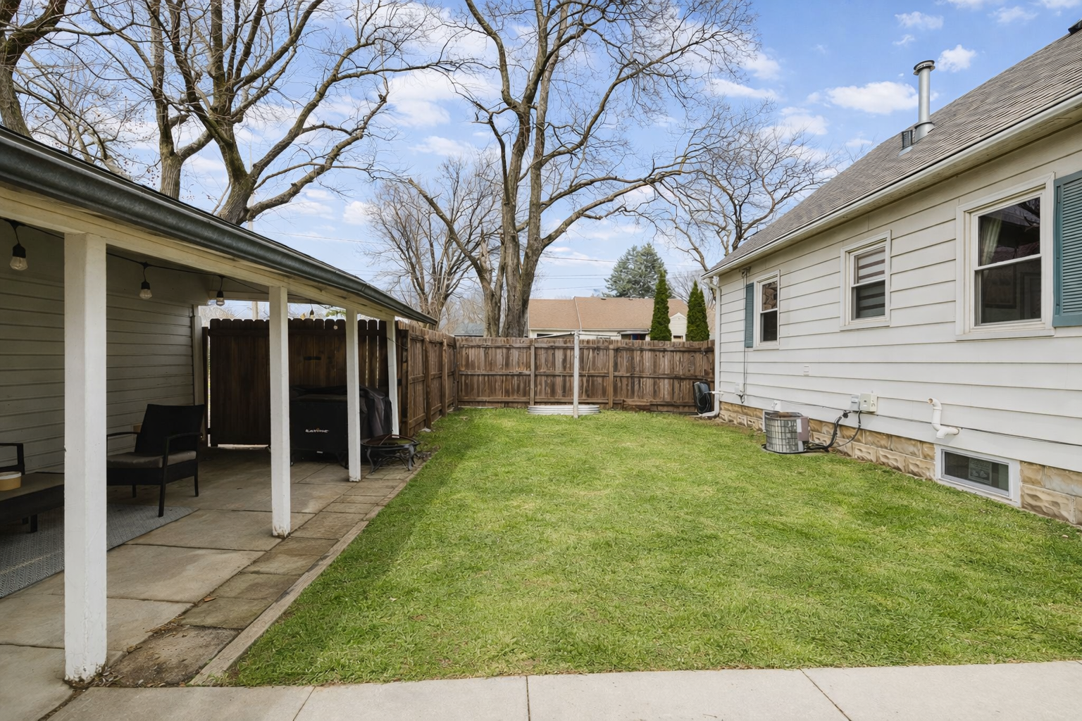 Suburban backyard with covered patio.png