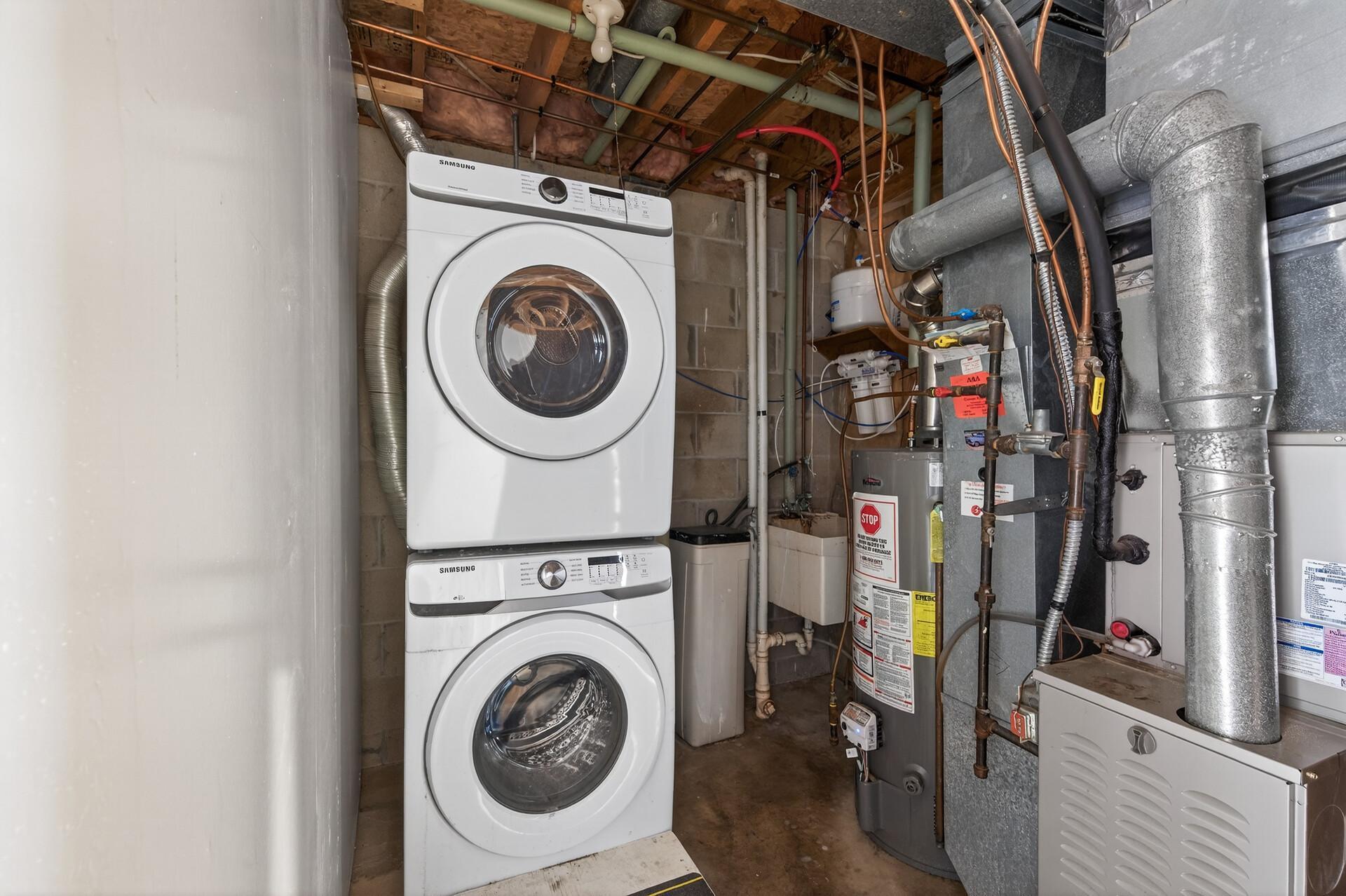 utility room with stackable washer/dryer