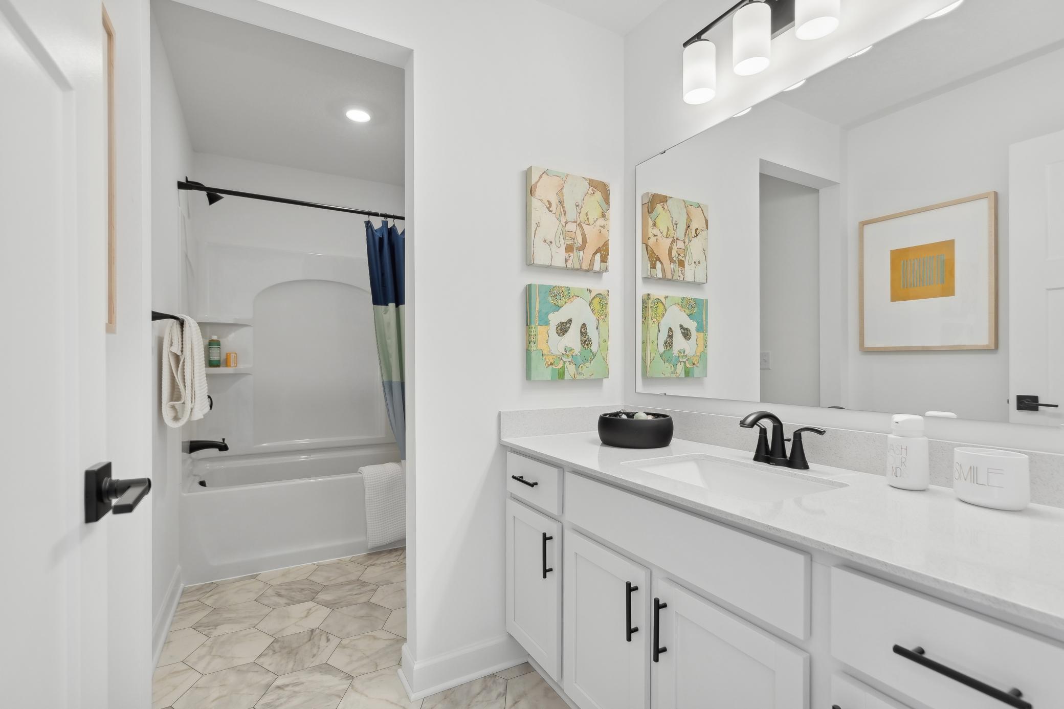 (Photo of a decorated model, actual homes finishes will vary) This stunning full bath is one of two baths located on the home’s upper level.
