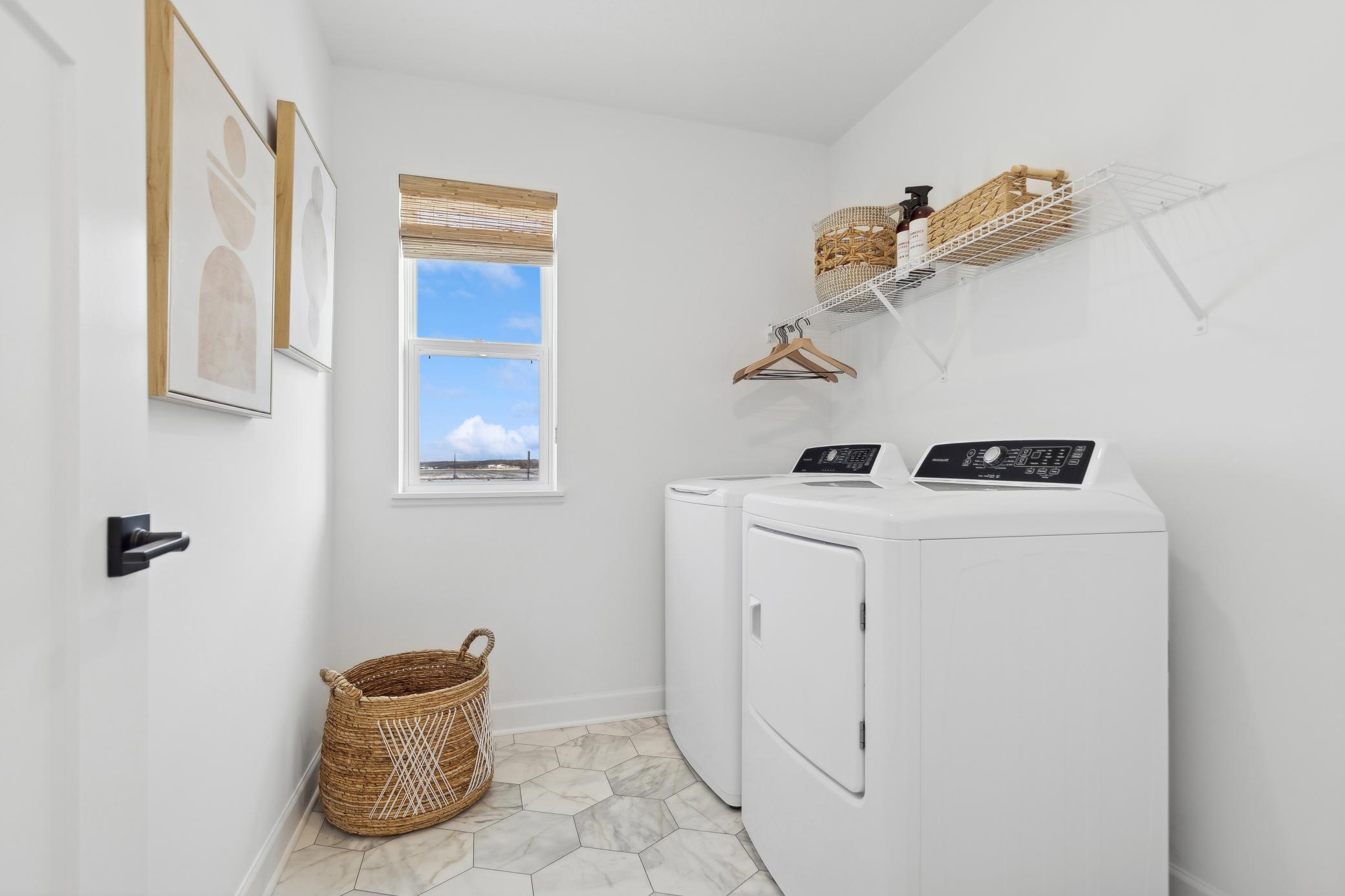 (Photo of a decorated model, actual homes finishes will vary) Upper level laundry.