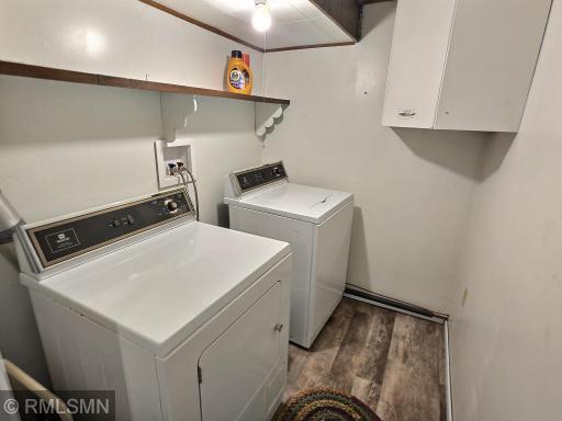 The laundry room in the lower level includes LVP flooring, nice lighting, and shelving for detergent and all of your laundry needs.