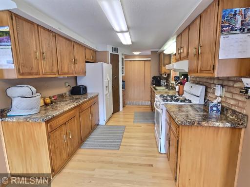 Views of the kitchen as you come from the formal dining space showcase the many cabinets and counter space.