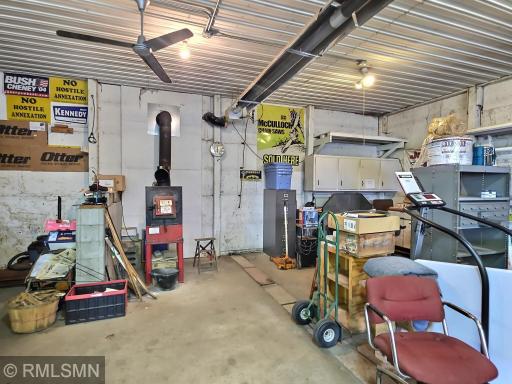 The "SHOP!" This incredible space can be enjoyed all year long with the wood stove heater and radiant heat as seen. Plenty of storage, parking, working space here.