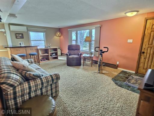 The main level living room is spacious in size and opens from the front entrance. Sunshine beams through and brightens the entire main level of this home, with the many windows throughout.