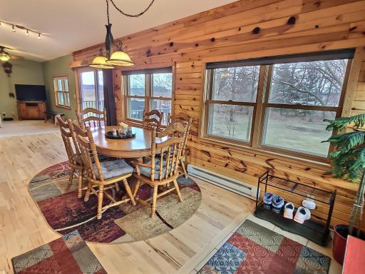 The warmth of the knotty pine pairs well with the wood floors and makes for an incredible dining space.