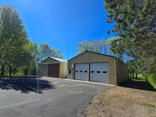 The sizable asphalt pad leads you to the two shops! The first of the two outbuildings boasts 45'x30', 2, 10-foot doors, a concrete floor, insulated, heated with the wood stove/radiant heat, electricity, and access to the second shed.