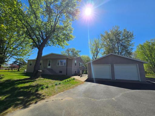 Welcome home! Guests are welcome through the covered front door or side door that sits behind the detached garage.