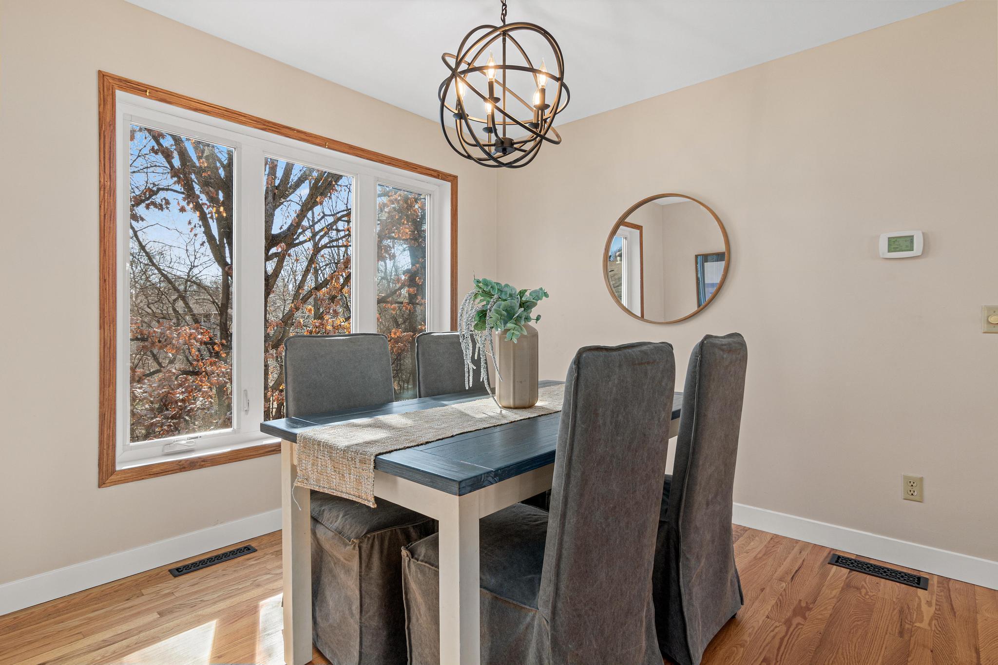 Spacious dining area with a view of the backyard.