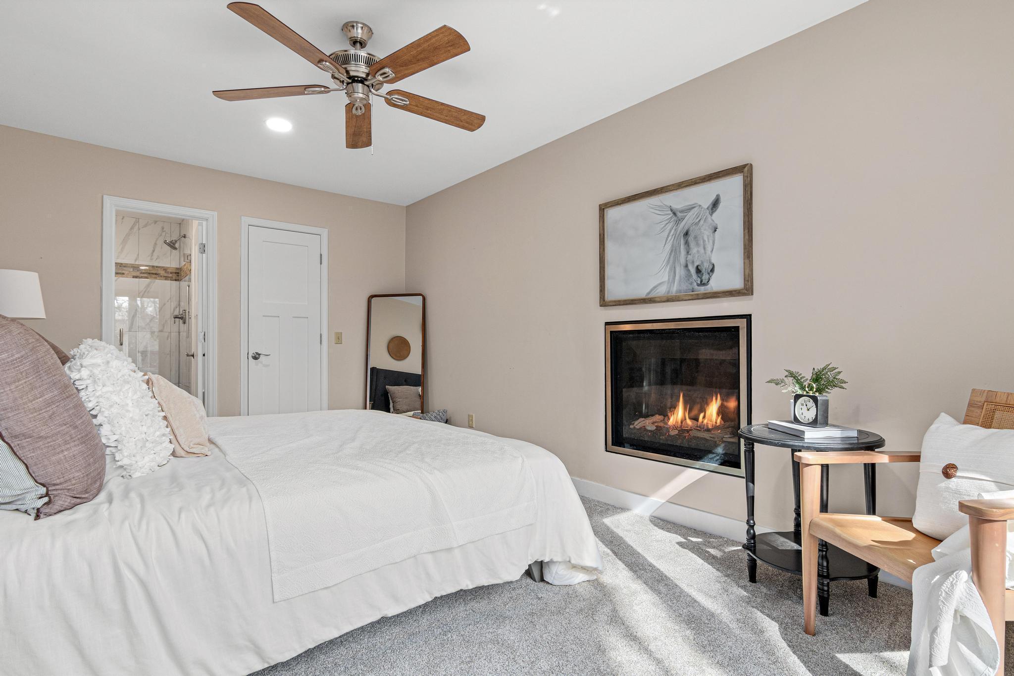 This primary bedroom is the perfect place to unwind and relax! It includes a gas-burning fireplace, walk-in closet, private 3/4 bathroom, and a large window.