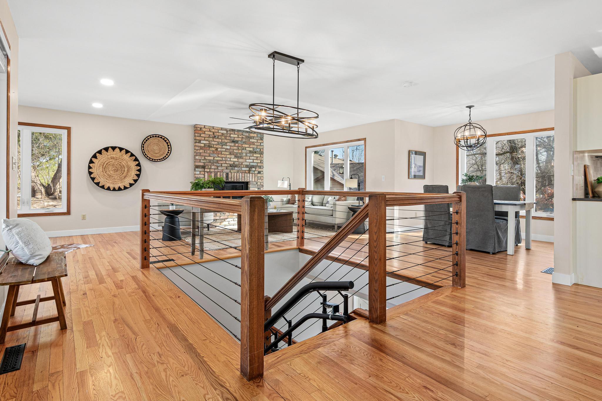 This open-concept main living area is filled with natural sunlight from the large, beautiful windows.